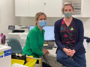 General Practitioner and Registered Nurse with face mask inside patient room in GP clinic in Mornington