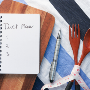 A white diary with dietary recommendations to support weight loss through Keto, gluten-free or vegan options at weight management clinic
